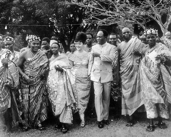 Original caption: 1/20/1963-Accra, Ghana- Ghana President Kwame Nkrumah (in suit) and his Egyptian-born wife, Madame Fathia Nkrumah (on Nkrumah's right), are flanked by paramount Chieftains as they dance to high life music here recently during a reception. The affair was staged on the grounds of Flagstaff House in Accra. January 20, 1963 Accra, Ghana